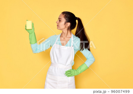 woman in gloves and cleaner apron cleaning with yellow sponge woman in gloves and cleaner apron cleaning with yellow sponge 96007499