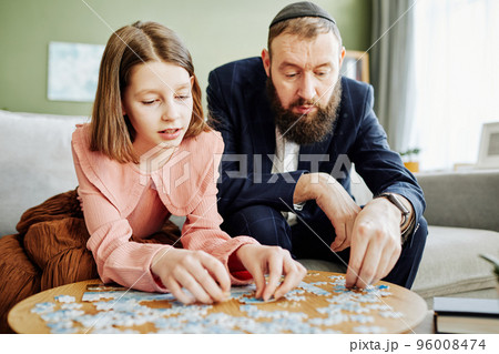 Father And Daughter Doing Puzzles Father And Daughter Doing Puzzles 96008474