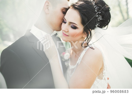 Kissing wedding couple in spring nature close-up portrait 96008683