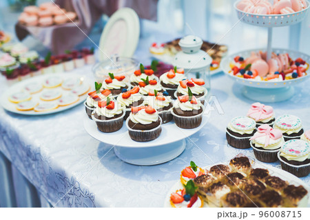 Delicious sweets on wedding candy buffet with desserts, cupcakes 96008715