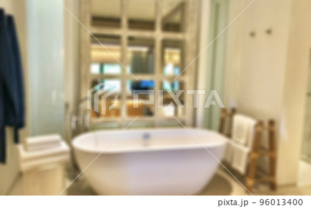 Blur bathroom interior background and white spa towels on wood Blur bathroom interior background and white spa towels on wood 96013400