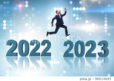 Businessman jumping from the year 2022 to 2023 Businessman jumping from the year 2022 to 2023 96014695