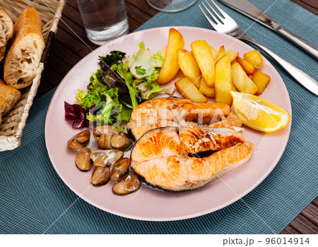 Deliciously steak of salmon with mushrooms and potatoes Deliciously steak of salmon with mushrooms and potatoes 96014914