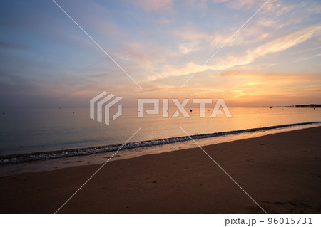 Calm sea shore with crushing waves on sandy beach at sunrise. Calm sea shore with crushing waves on sandy beach at sunrise. 96015731