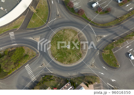 Aerial view of road roundabout intersection with fast moving heavy traffic. Urban circular transportation crossroads 96016350