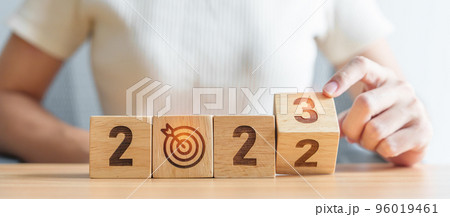 woman hand change 2022 to 2023 block with dartboard icon. Goal, Target, Resolution, strategy, plan, Action, mission, motivation, and New Year start concepts 96019461