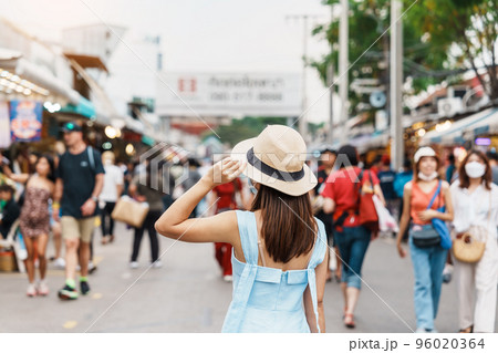woman traveling with hat, Asian traveler standing at Chatuchak Weekend Market, landmark and popular for tourist attractions in Bangkok, Thailand. Travel in Southeast Asia concept woman traveling with hat, Asian traveler standing at Chatuchak Weekend Market, landmark and popular for tourist attractions in Bangkok, Thailand. Travel in Southeast Asia concept 96020364
