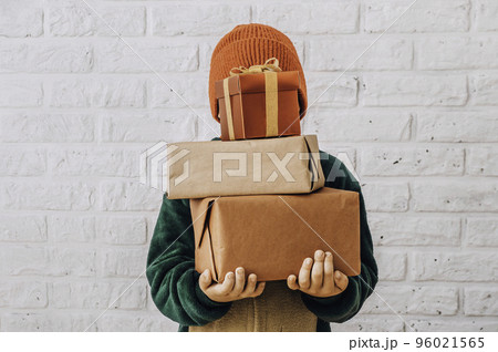 Holiday gifts christmas background with many gift boxes wrapping in zero waste style. Many gift boxes in boys hands Christmas web banner 96021565