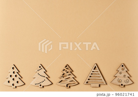 New Year's beige card, with a pattern of Christmas trees. Beige Christmas background for inscriptions. Clipart for a minimalistic Christmas card. Frame. Christmas trees top view. Winter holiday New Year's beige card, with a pattern of Christmas trees. Beige Christmas background for inscriptions. Clipart for a minimalistic Christmas card. Frame. Christmas trees top view. Winter holiday 96021741