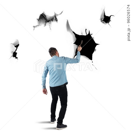 Man breaks a wall with a hammer 96026574