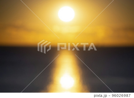 Blurred background. Sun shining in sky with clouds during sunset dawn. Sunrise dawning sundown. Sunny path, sunny walkway on surface of sea waves. Sunlight. Sea landscape. Natural blurry bokeh texture Blurred background. Sun shining in sky with clouds during sunset dawn. Sunrise dawning sundown. Sunny path, sunny walkway on surface of sea waves. Sunlight. Sea landscape. Natural blurry bokeh texture 96026987