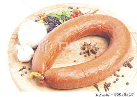 Krakow sausage with spices and garlic on cutting board 96028219