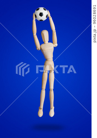 Football wooden toy figure on blue 96028691