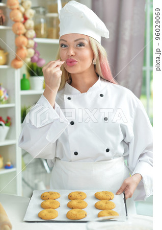 Young woman cooking healthy food in kitchen Young woman cooking healthy food in kitchen 96029069