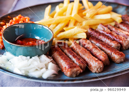 Traditional Cevapcici, ground meat rolls with french fries. Porec, Croatia. 96029949