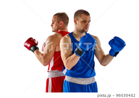 Rivals. Two twins brothers, professional boxers in blue and red sportswear boxing isolated on white background. Concept of sport, competition, training, energy. 96030482