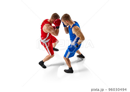 Aerial view of two muscular professional boxers in blue and red sportswear training isolated on white background. Professional sport 96030494