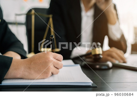 Legal counsel presents to the client a signed contract with gavel and legal law. justice and lawyer concept in office. Legal counsel presents to the client a signed contract with gavel and legal law. justice and lawyer concept in office. 96030684