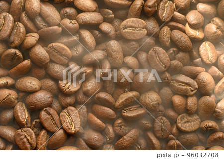 The texture of freshly roasted, ready-to-drink coffee, steam rising above the beans, black ava beans. The texture of freshly roasted, ready-to-drink coffee, steam rising above the beans, black ava beans. 96032708
