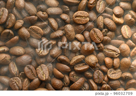 Black coffee beans with a slight haze from the steam, the texture of coffee beans. 96032709