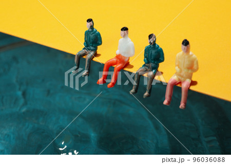 Concept of summer, toy people sit near water Concept of summer, toy people sit near water 96036088