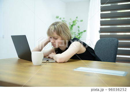 オフィスで働く疲れて居眠りする女性 オフィスで働く疲れて居眠りする女性 96036252