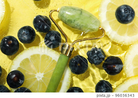 Concept of fresh summer fruits, blueberry, lemons and face roller 96036343
