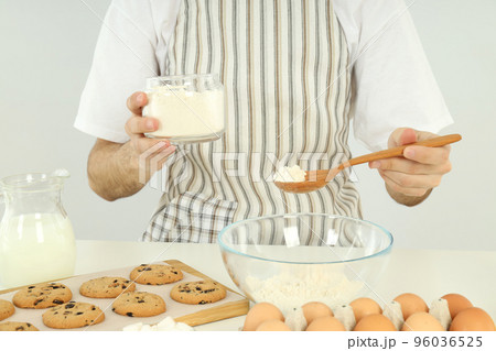 Concept of cooking, young man in apron cook cookies 96036525
