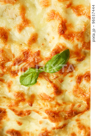 Lasagna with basil on whole background, close up Lasagna with basil on whole background, close up 96037444