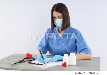 Young female doctor sitting on his workplace 96037506
