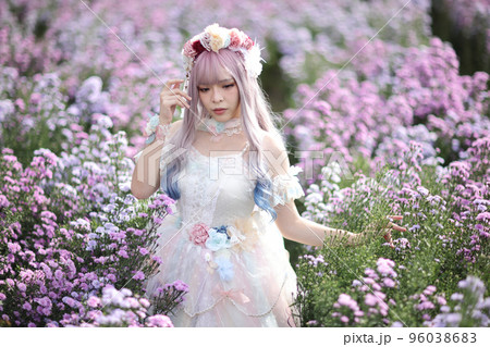 Beautiful young woman with white lolita dress with flowers garden Japanese fashion 96038683