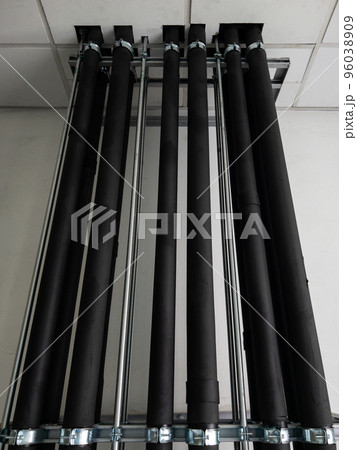 The complex row of the metal pipe with the black rubber case. The complex row of the metal pipe with the black rubber case. 96038909