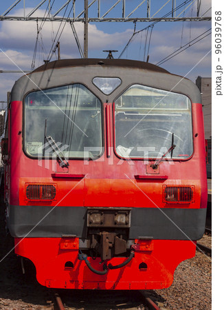 View of the head wagon of an electric train on the railway tracks on the station platform. 96039768