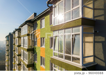 Aerial view of a tall residential apartment building with many windows and balconies. 96040088