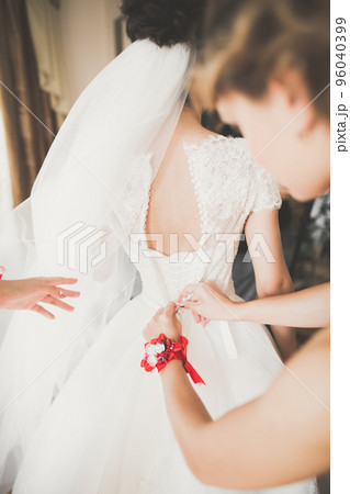 Gorgeous bride in robe posing and preparing for the wedding ceremony face in a room 96040399