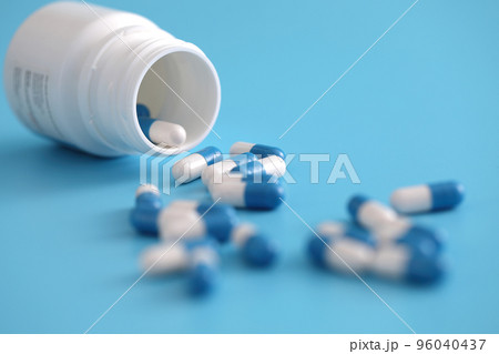 pills capsules with bottle isolated on blue background pills capsules with bottle isolated on blue background 96040437
