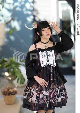 Portrait of asian girl in lolita fashion dress in vintage garden background Portrait of asian girl in lolita fashion dress in vintage garden background 96040598