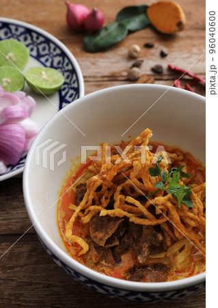 Local northern Thai food Egg noodle curry with beef on wood background Local northern Thai food Egg noodle curry with beef on wood background 96040600