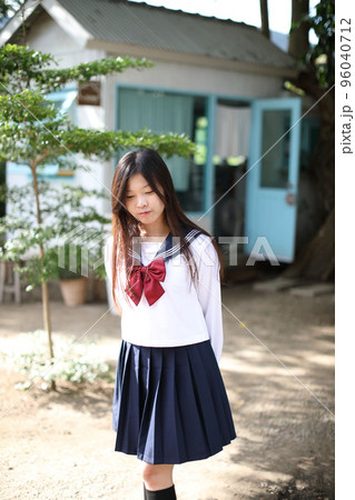 Japanese school girl in local coffee shop 96040712