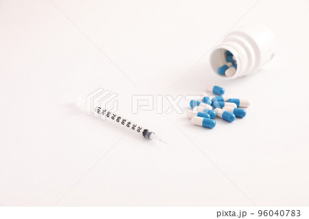 Syringe and pill isolated in white background Syringe and pill isolated in white background 96040783