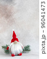 Christmas elf in red hat with fir branch holiday card on light winter background 96041473