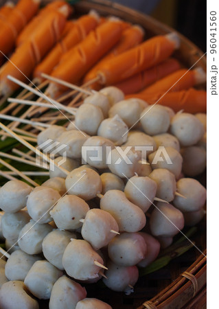 closeup pork meatballs skewers and sausage stacked and green pandan leaf on a bamboo tray closeup pork meatballs skewers and sausage stacked and green pandan leaf on a bamboo tray 96041560