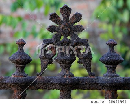 Old brown rusty weathered fence ornament close up. Old brown rusty weathered fence ornament close up. 96041941