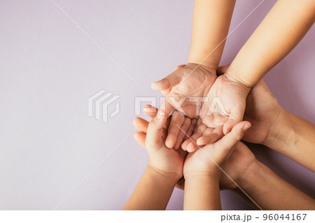 Closeup top view family hands stack palms studio shot isolated on purple background, parents and kid holding empty free space on hand together, Gesture sign of support and love, Family and parents day 96044167