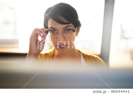 Bringing her vision of success into focus. Cropped shot of a young creative working on a computer in an office. 96044441