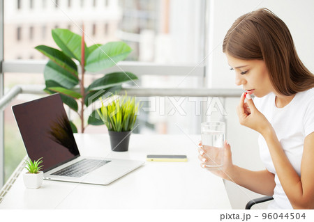 Beautiful Smiling Woman Taking Vitamin Pill, Dietary Supplement Beautiful Smiling Woman Taking Vitamin Pill, Dietary Supplement 96044504