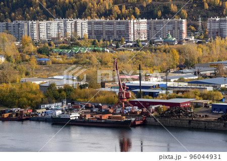 Industrial pier on the bank of the river with a loading crane. Russia Krasnoyarsk October 2022. 96044931