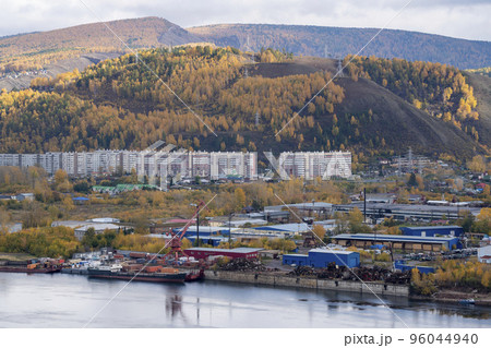 Industrial pier on the bank of the river with a loading crane. 96044940