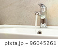Water faucet. Water flow in bathroom with sink. 96045261