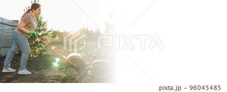 Banner woman laying sod for new garden lawn copy space - turf laying concept 96045485